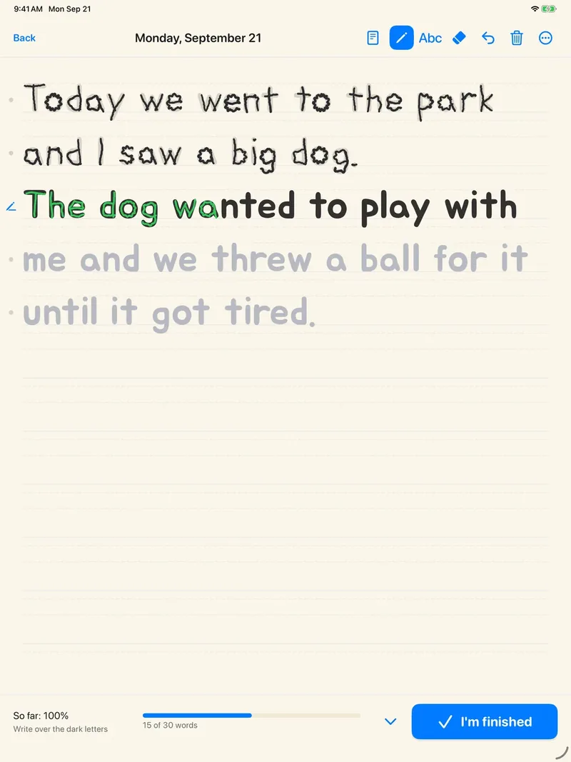 The Handwritten Journal writing page: two finished lines in a child’s handwriting, a line being traced in green ink, and pale spoken words waiting below.